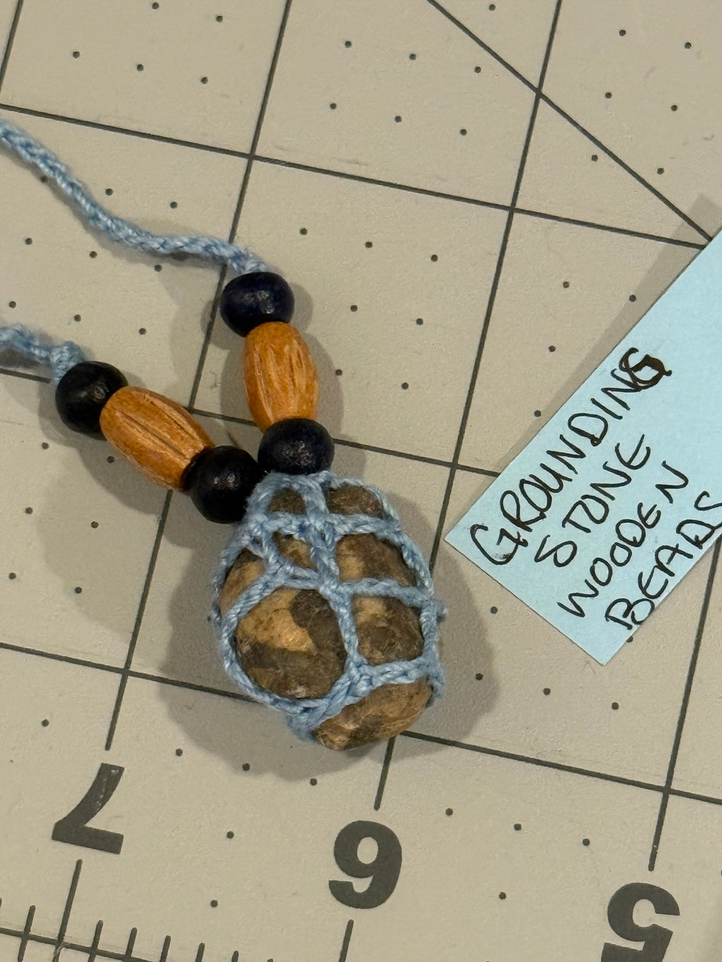 light blue grounding stone with wooden beads