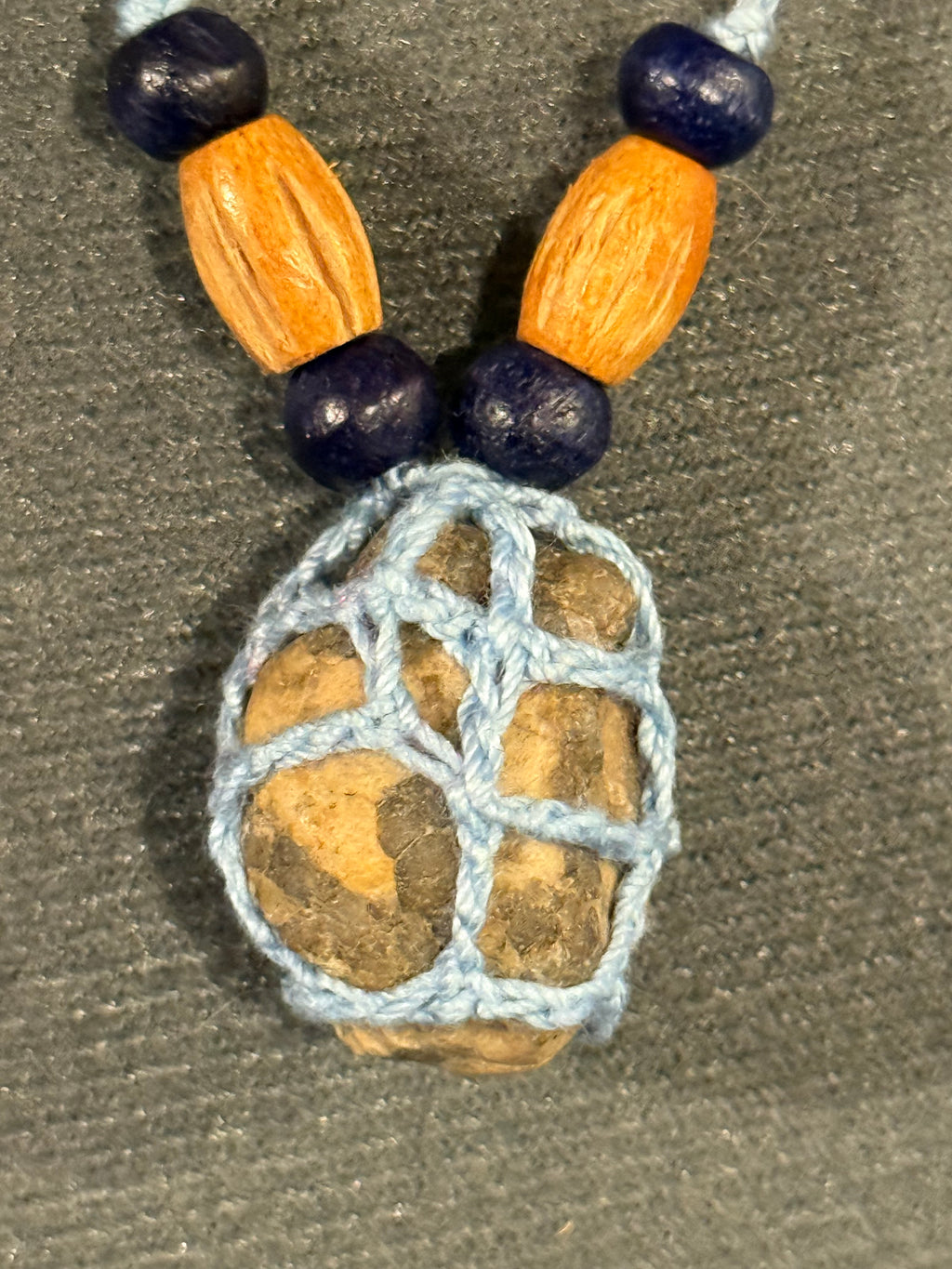 light blue grounding stone with wooden beads