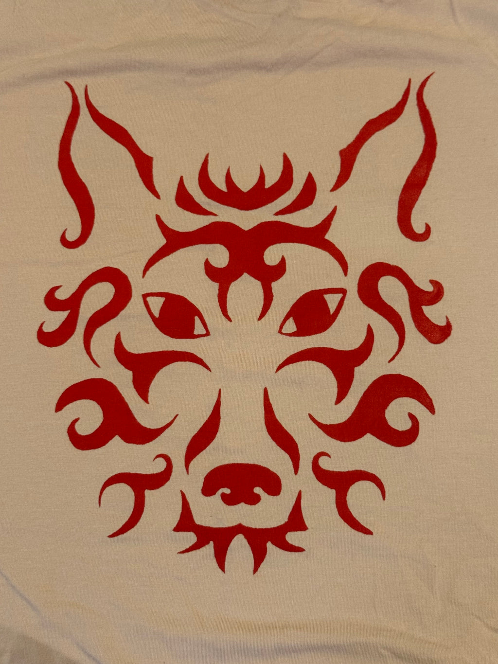 cream colored tank with red wolf