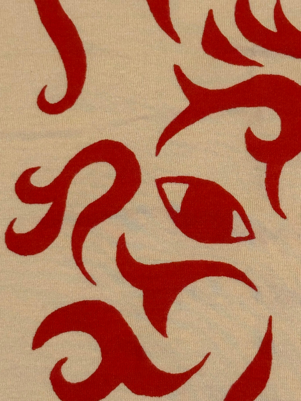 cream colored tank with red wolf