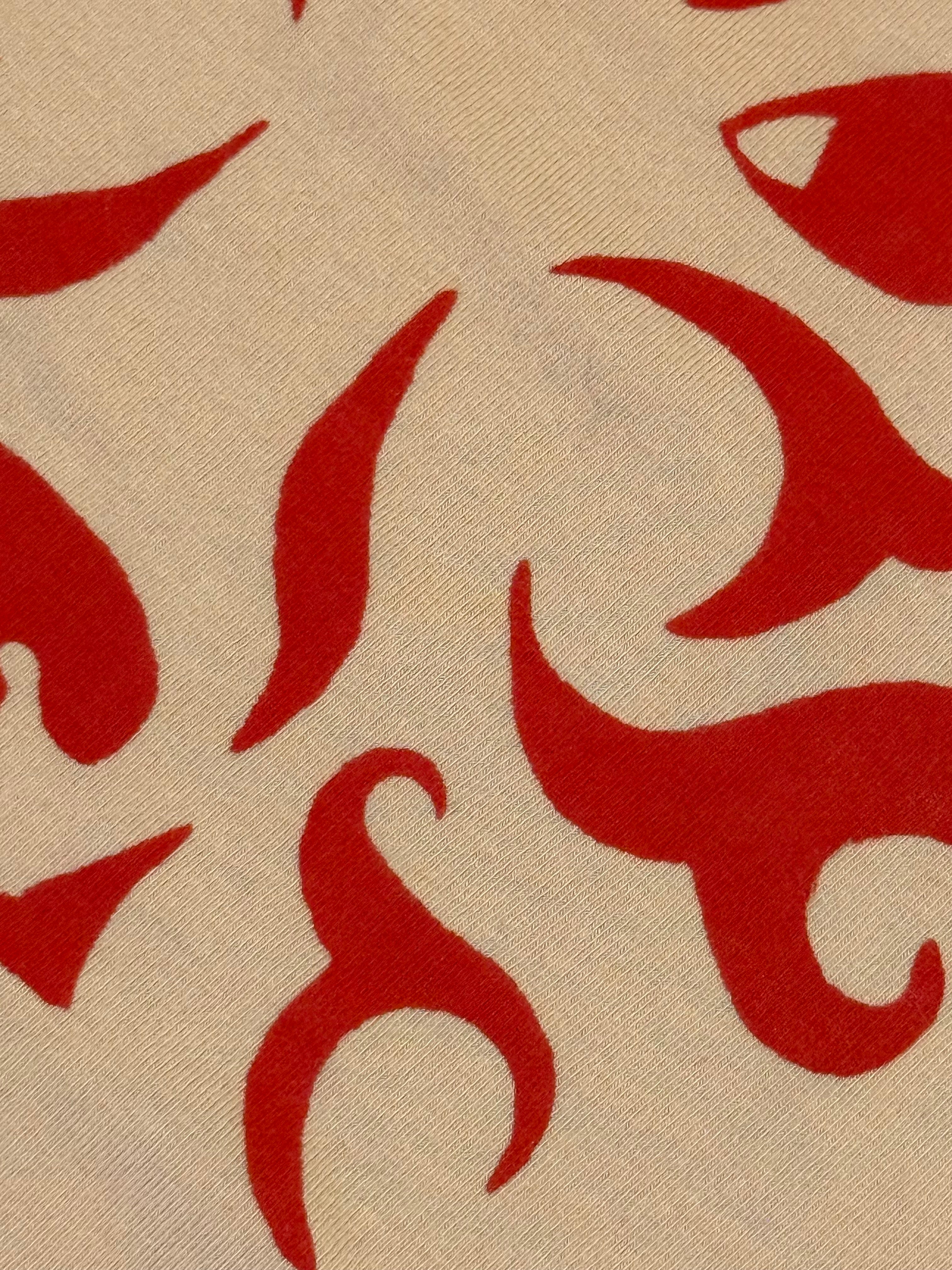 cream colored tank with red wolf