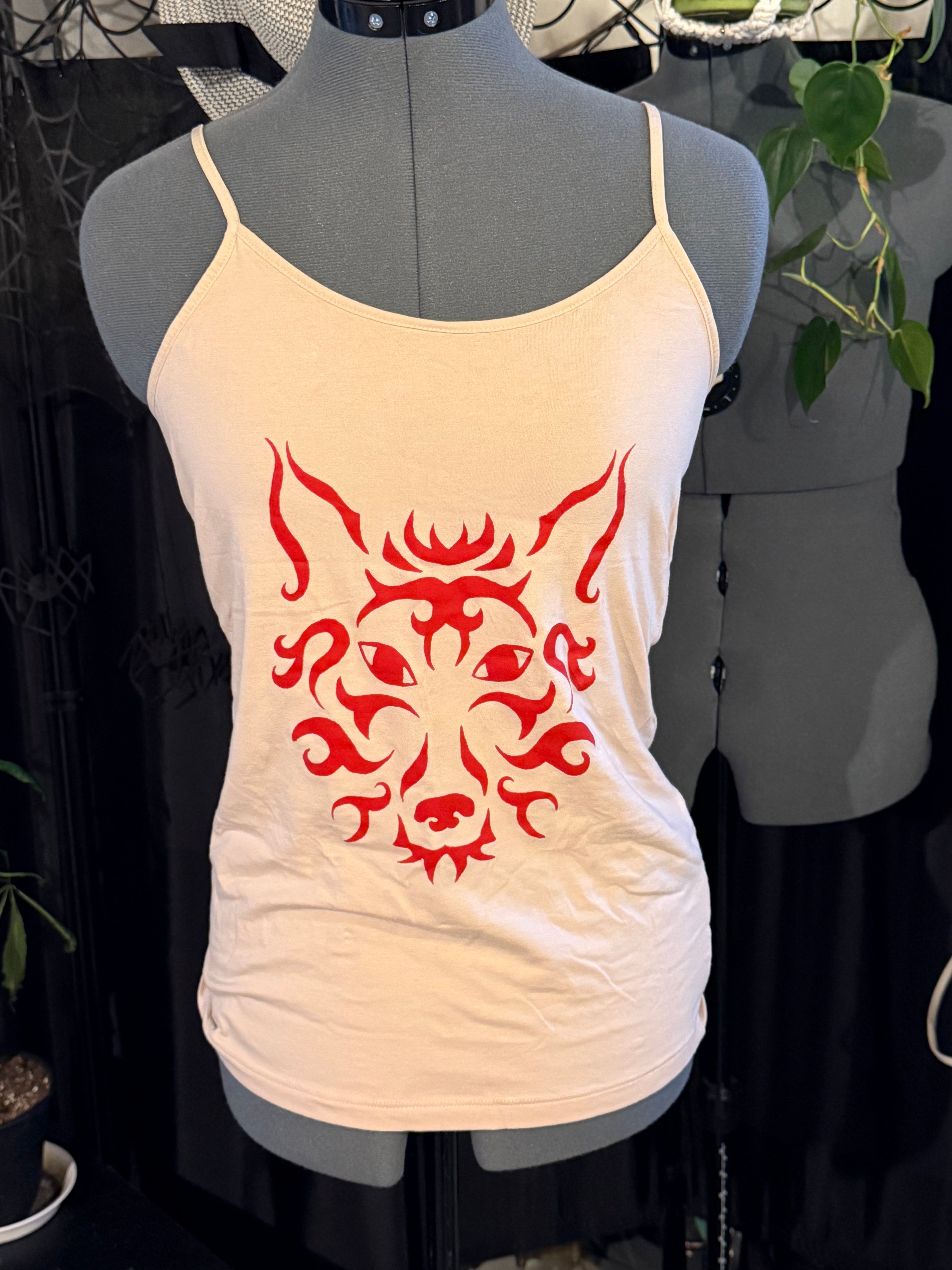 cream colored tank with red wolf