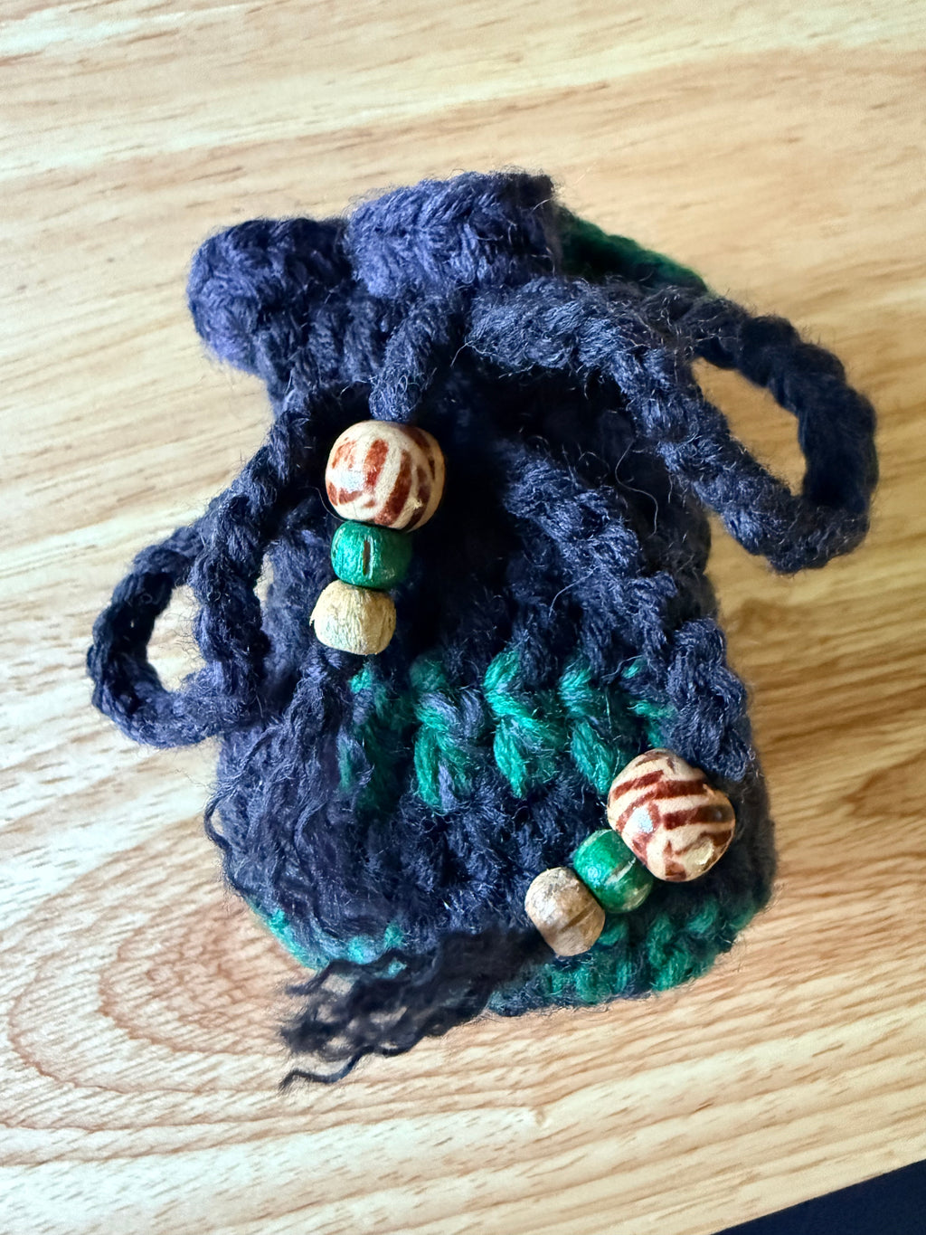 charcoal and green dice bag with 1 set of dice