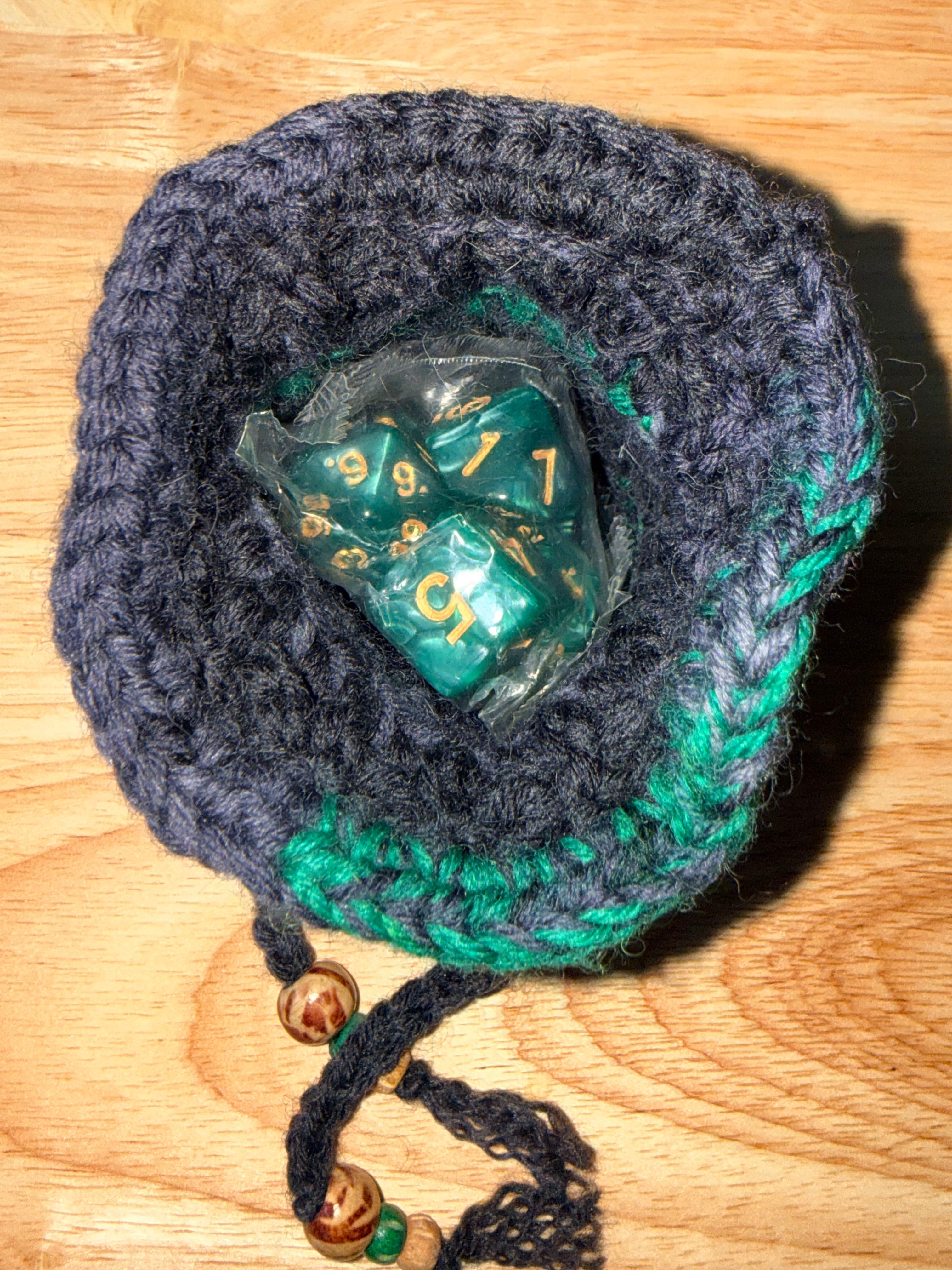 charcoal and green dice bag with 1 set of dice