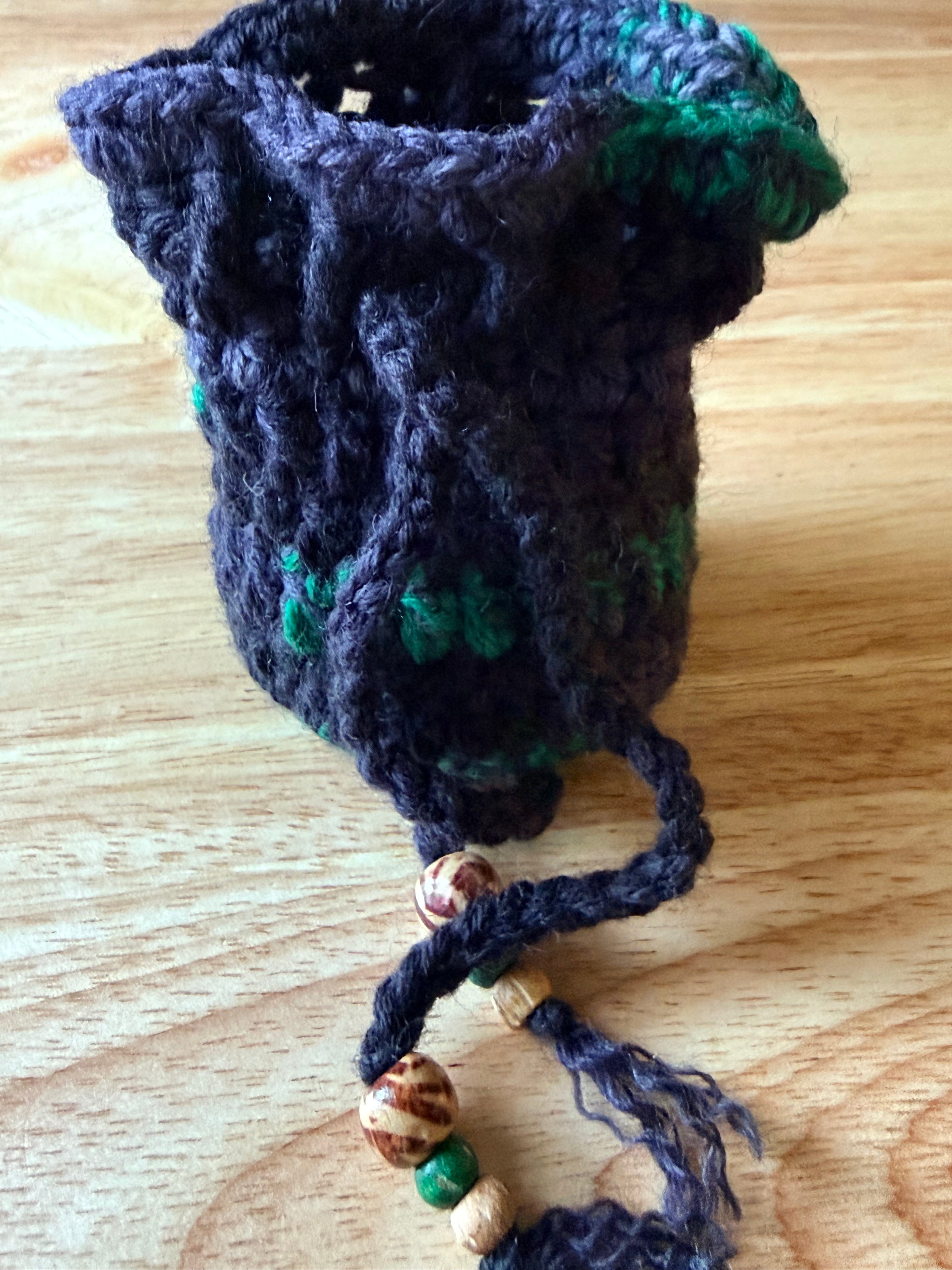charcoal and green dice bag with 1 set of dice