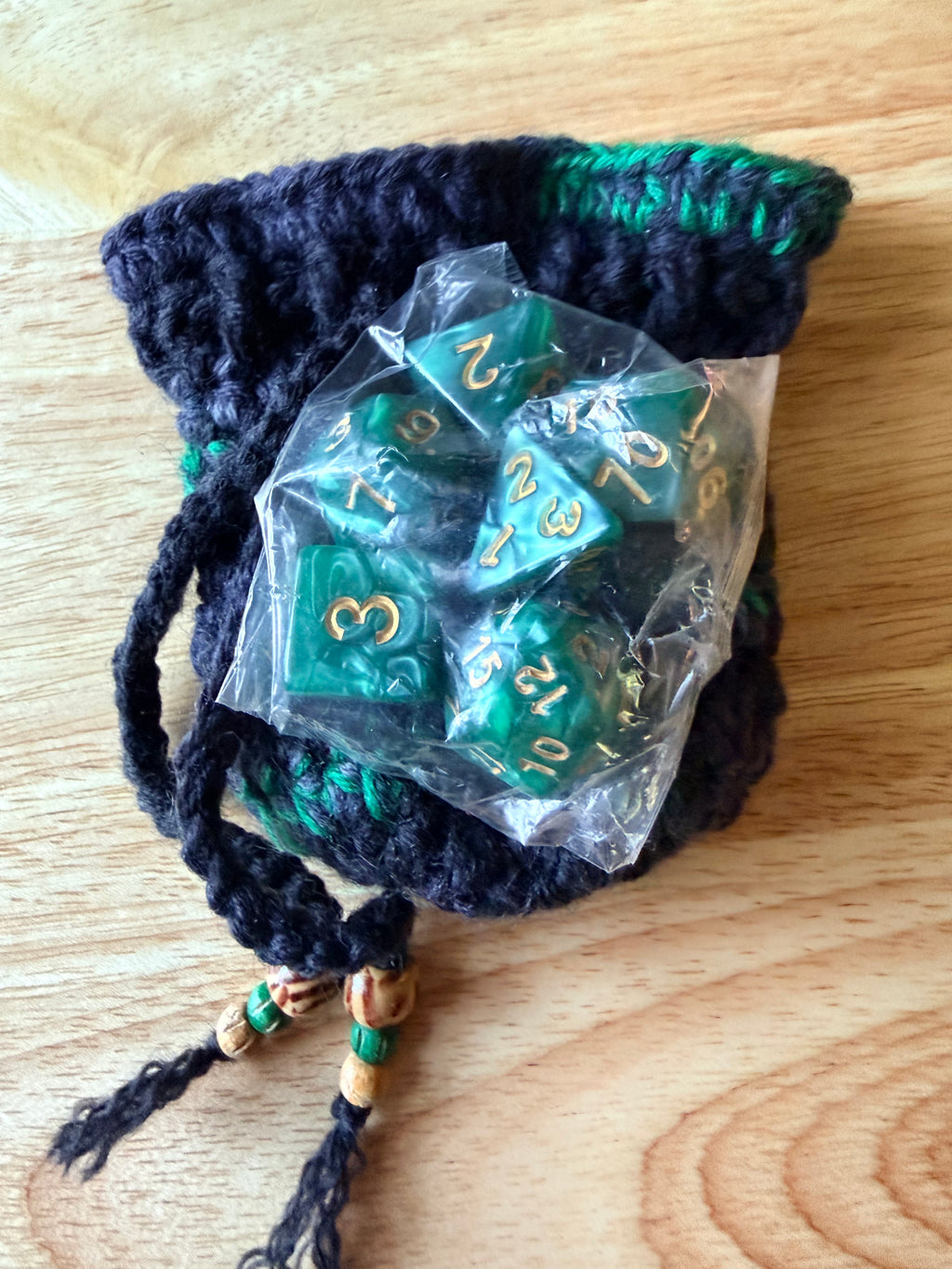 charcoal and green dice bag with 1 set of dice