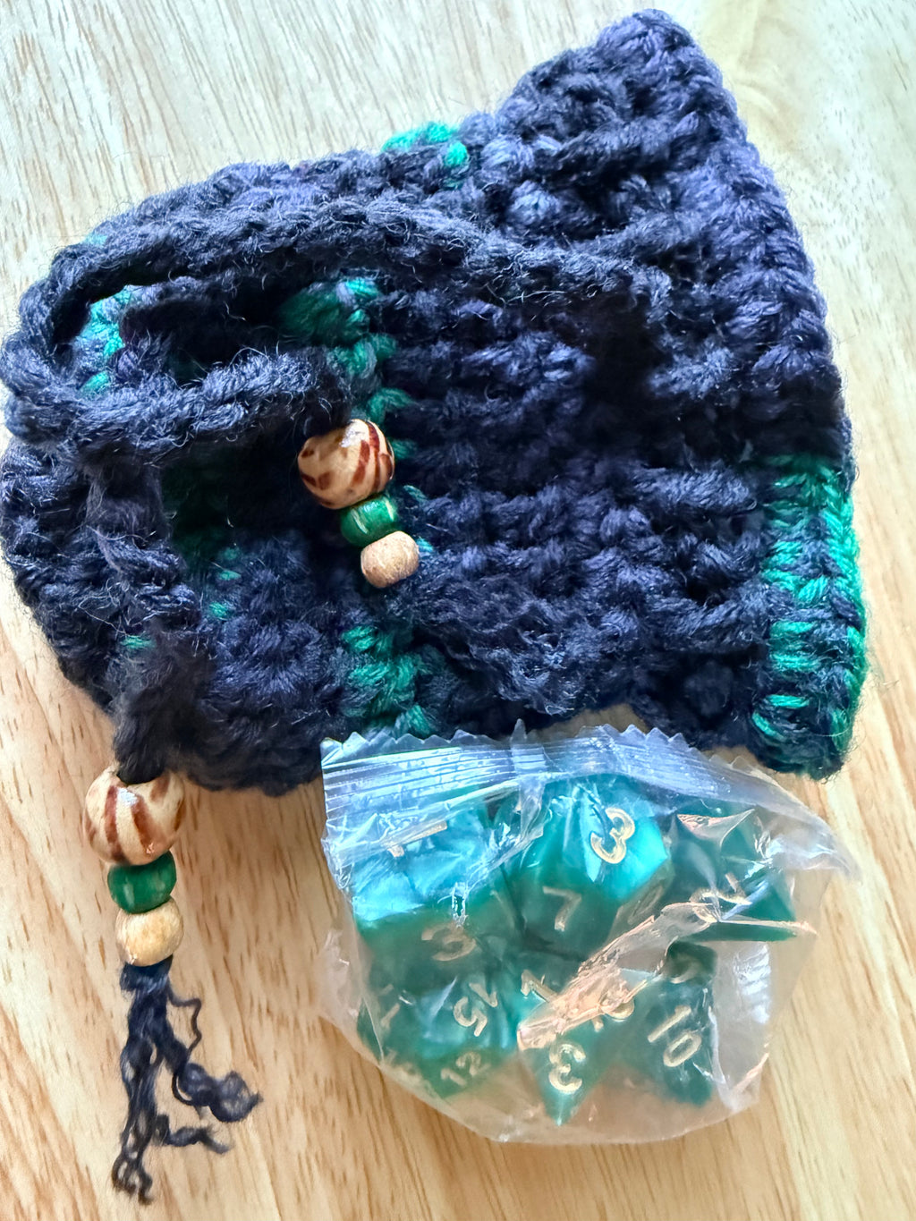 charcoal and green dice bag with 1 set of dice