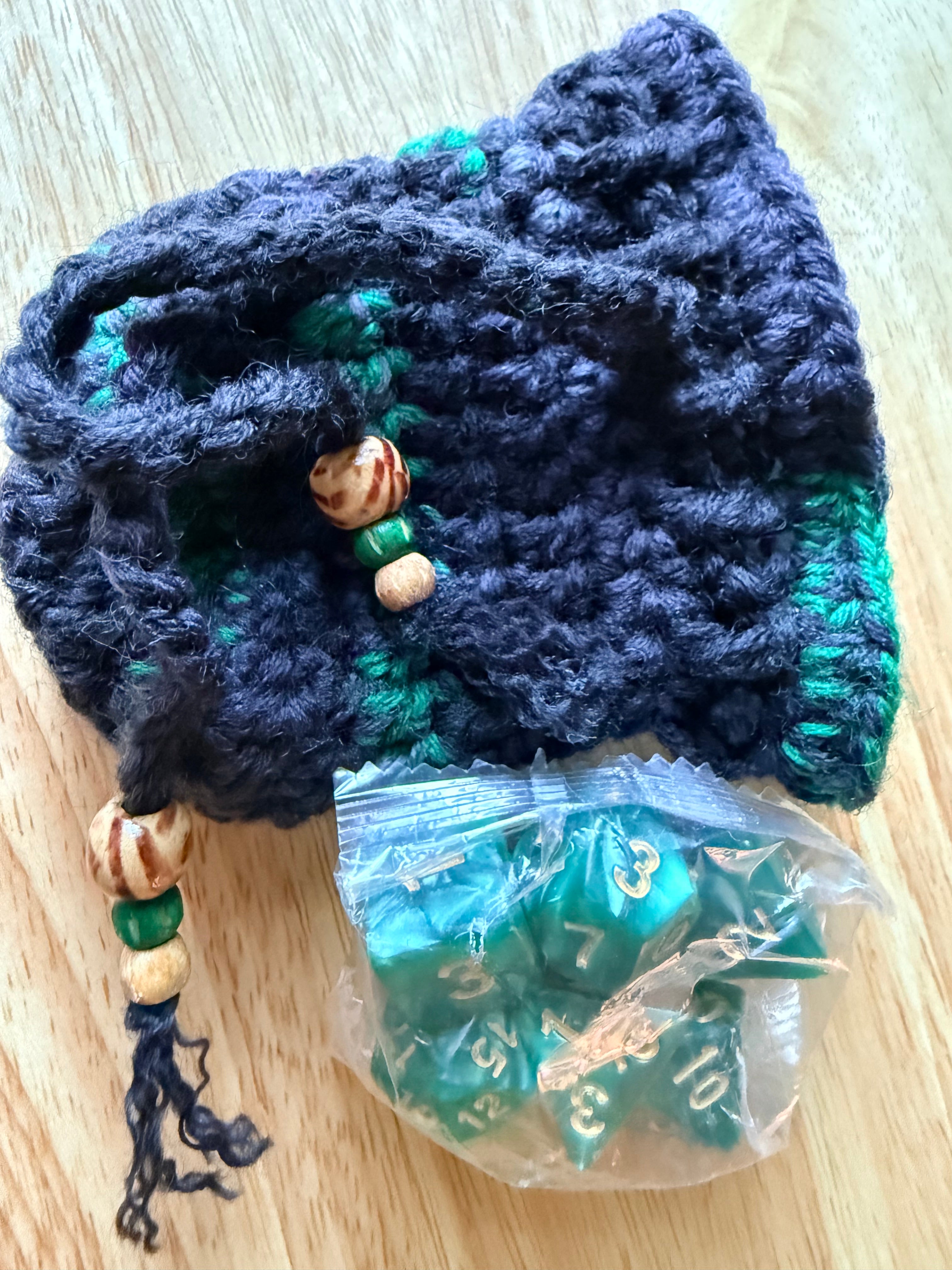 charcoal and green dice bag with 1 set of dice